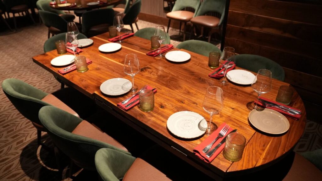 Private dining room with a long wooden table set for a group
