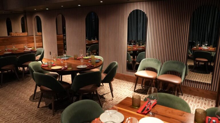 Round tables and green chairs in the private dining room