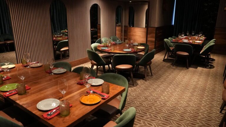 Place settings on a wooden table in the private dining room