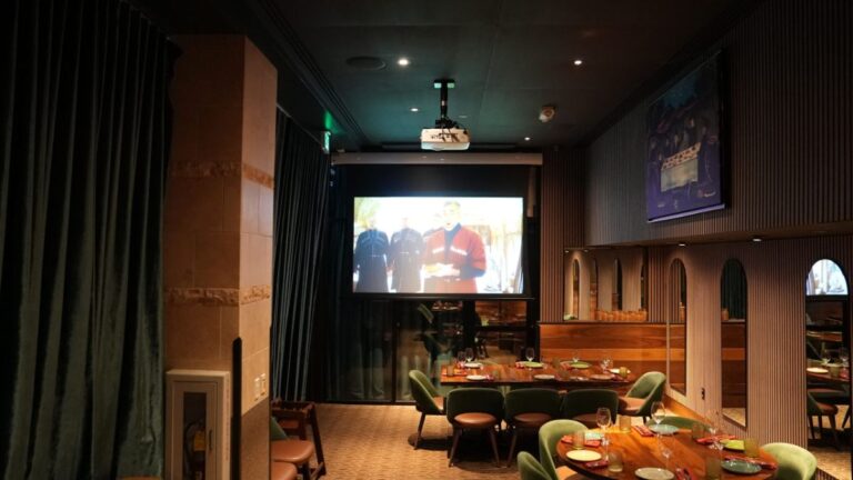 Private dining room set up with a presentation on the projector screen