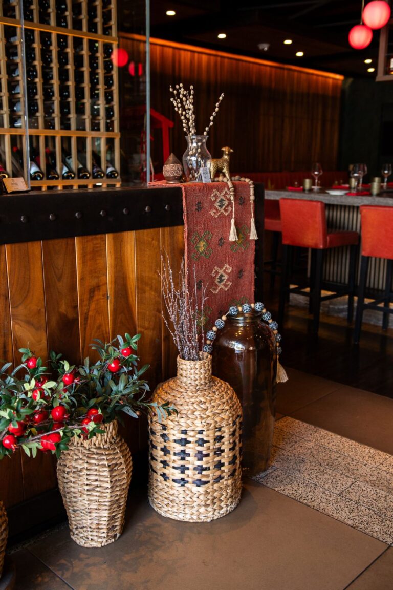 Restaurant entry area with woven vases, plants, and red lanterns