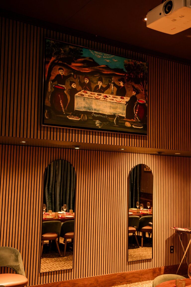 A wall painting above arched mirrors in the private dining room