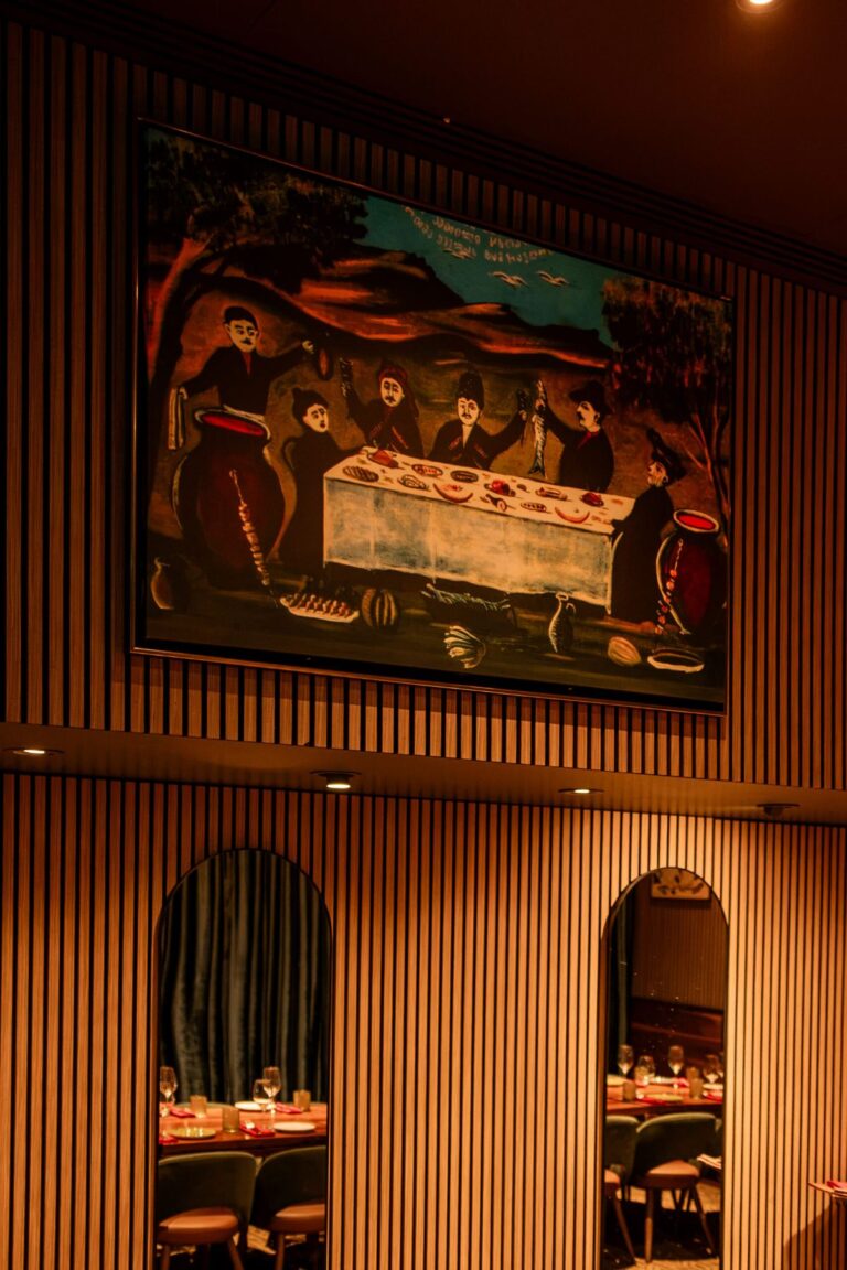 A wall painting above arched mirrors in the private dining room